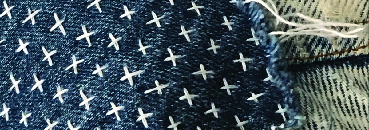 points de broderie en croix sur un tissus en denim